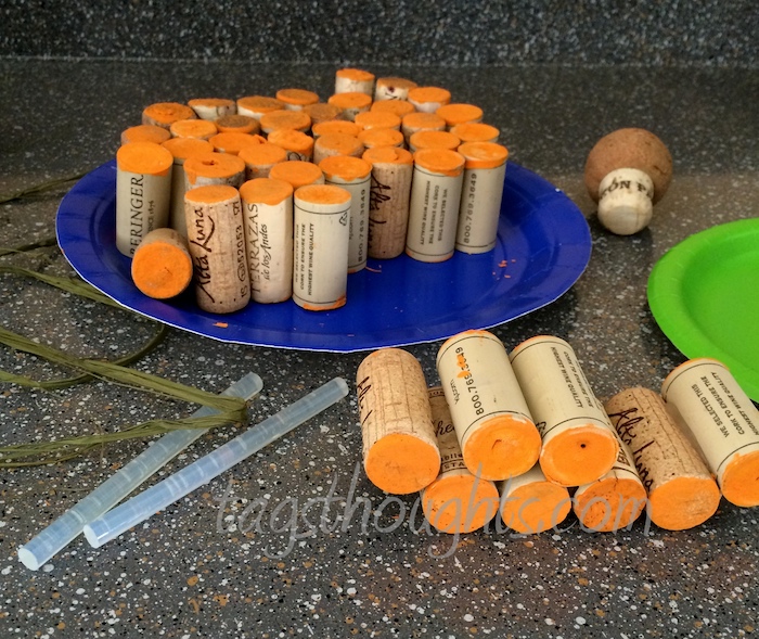 corks with orange ends on a dark surface