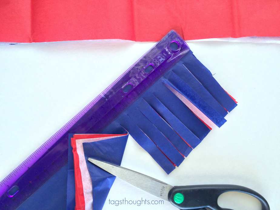 Red, white & blue tissue paper cut with scissors for sparklers.