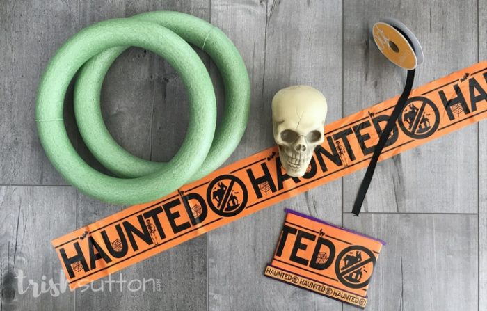 Haunted Halloween Wreath; Simple, spooky and festive Halloween decor made with Caution, Keep Out or Haunted Tape. October Dollar Store DIY by Trish Sutton.