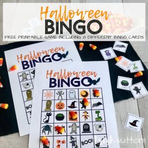 Halloween Bingo Cards on a black mat with candy corn bingo markers